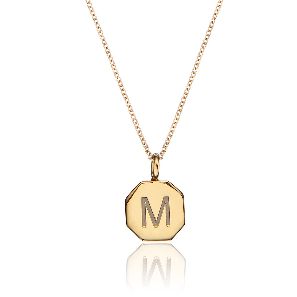 Gold personalised hexagon necklace with the letter 'M' engraved on it on a white background