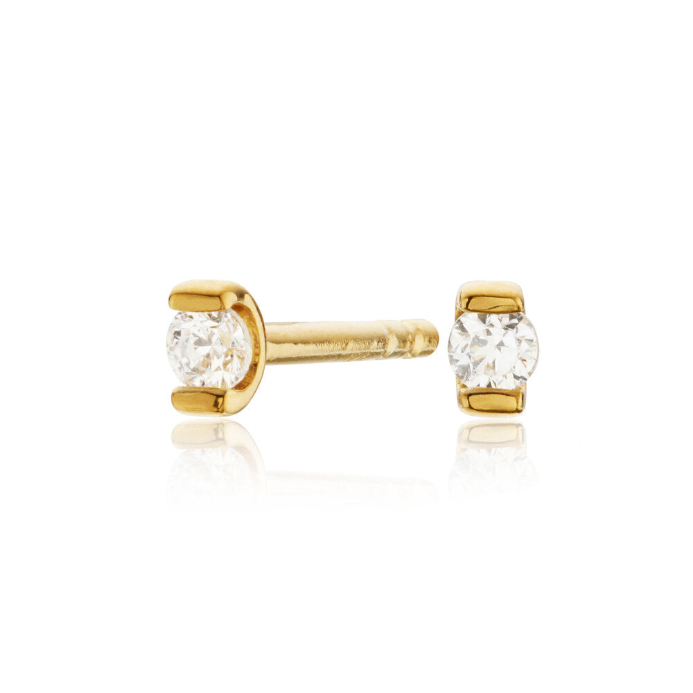 Gold small diamond style studs on a white background