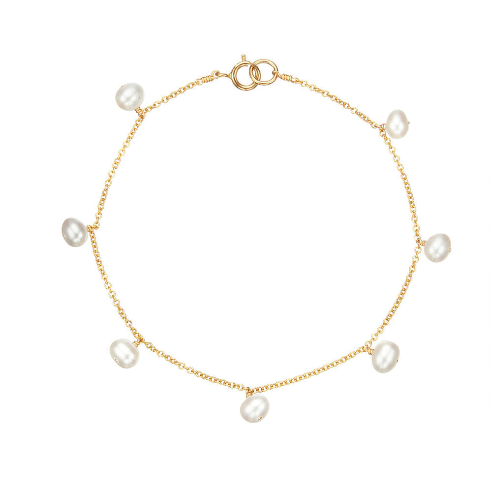 Gold pearl drop bracelet on a white background