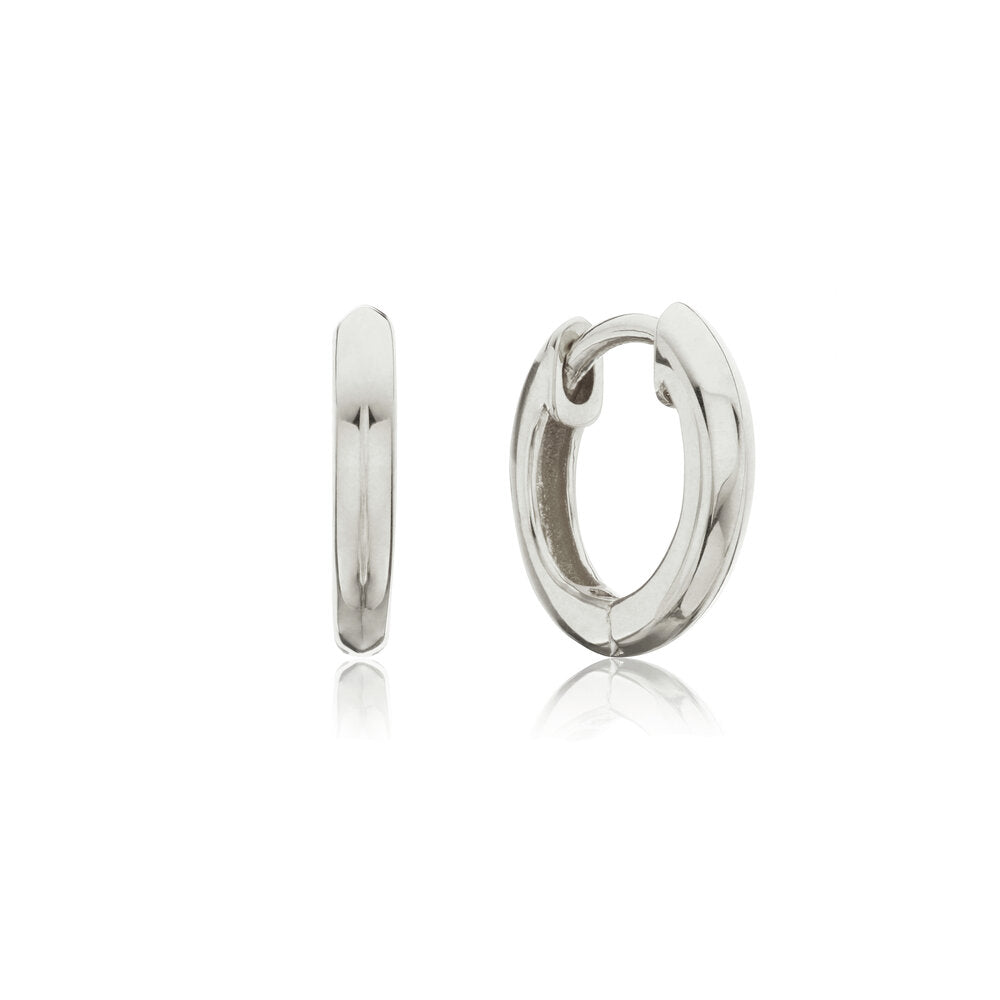 Silver small rounded plain huggie hoop earrings on a white background