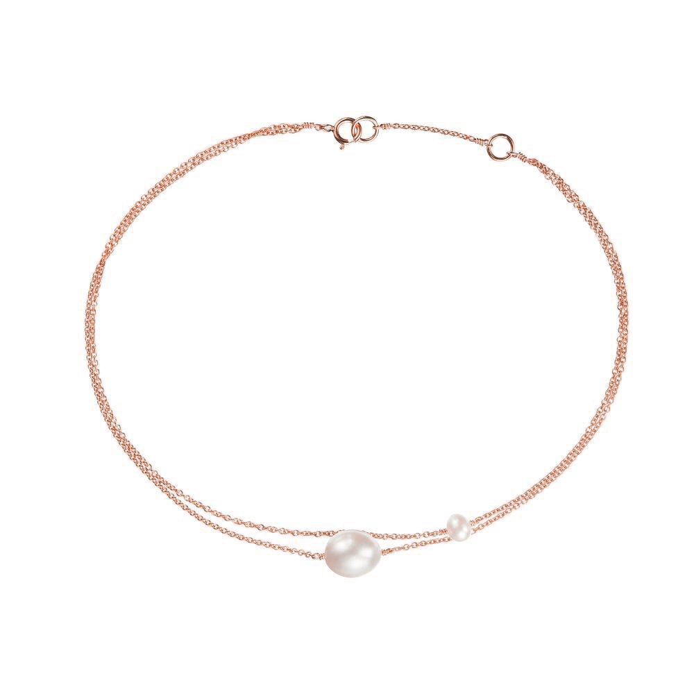 Rose gold layered large and small pearl anklet on a white background