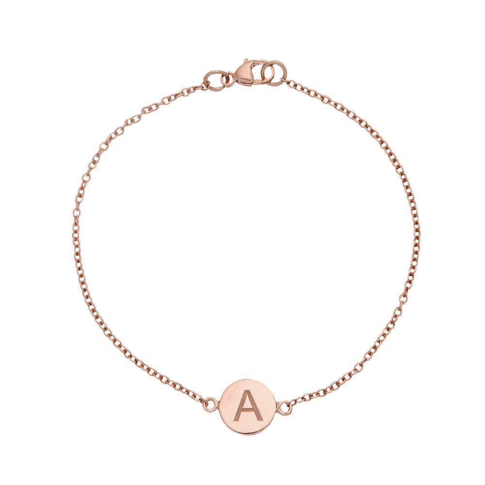 Rose gold personalised disc bracelet with the letter 'A' engraved on it on a white background