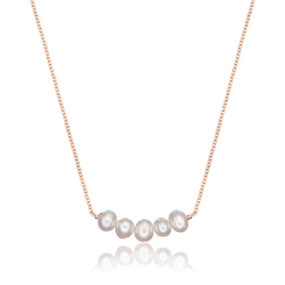 Rose gold pearl cluster necklace on a white background