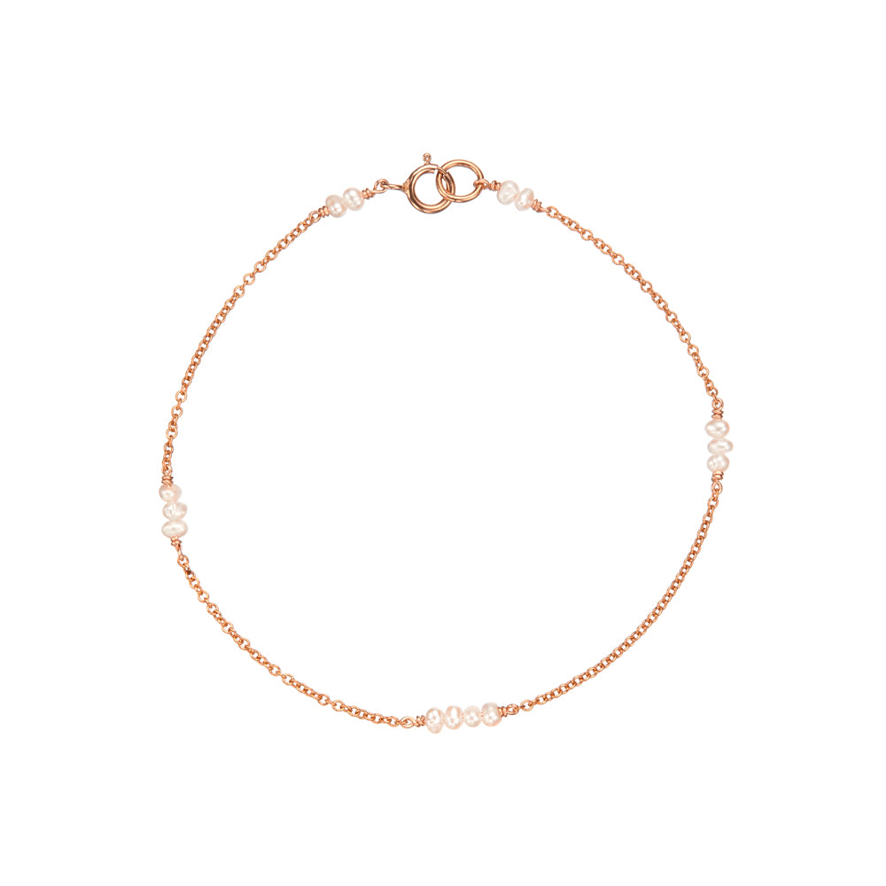 Rose gold mini pearl bracelet on a white background