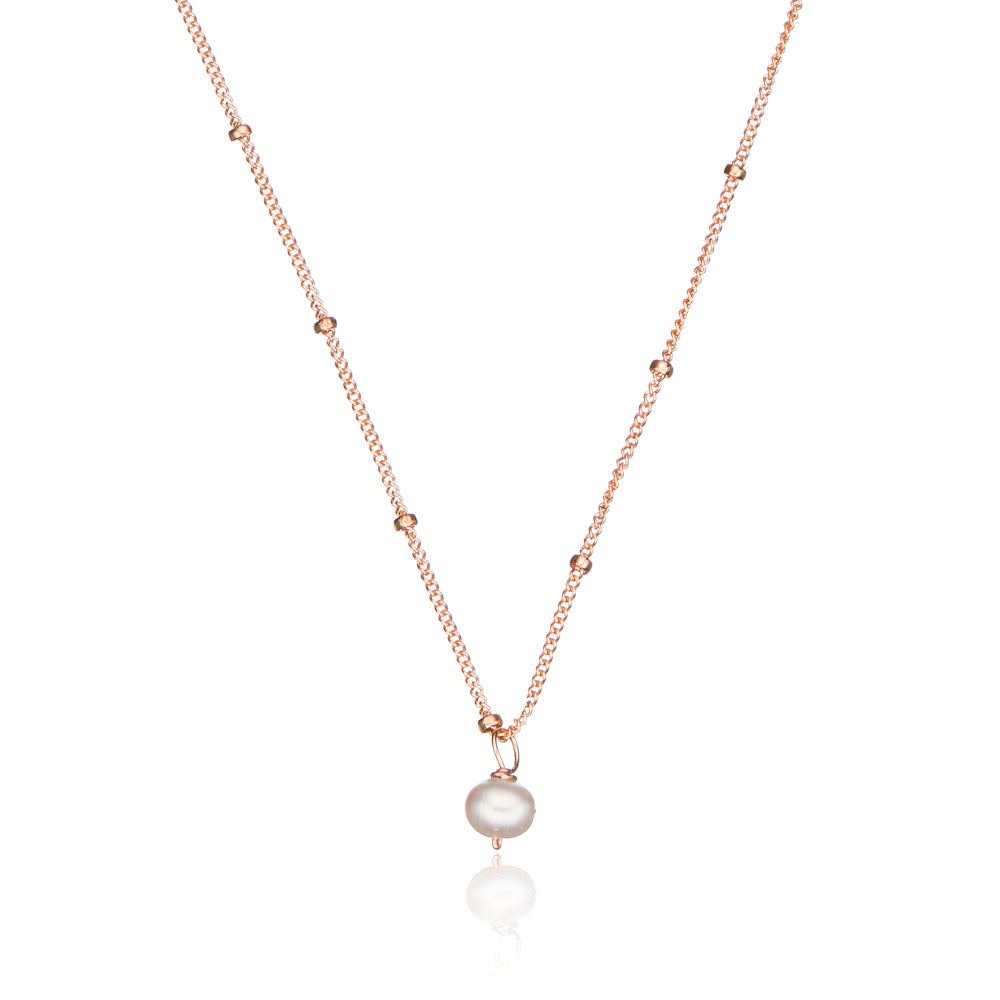 Rose gold single pearl satellite necklace on a white background