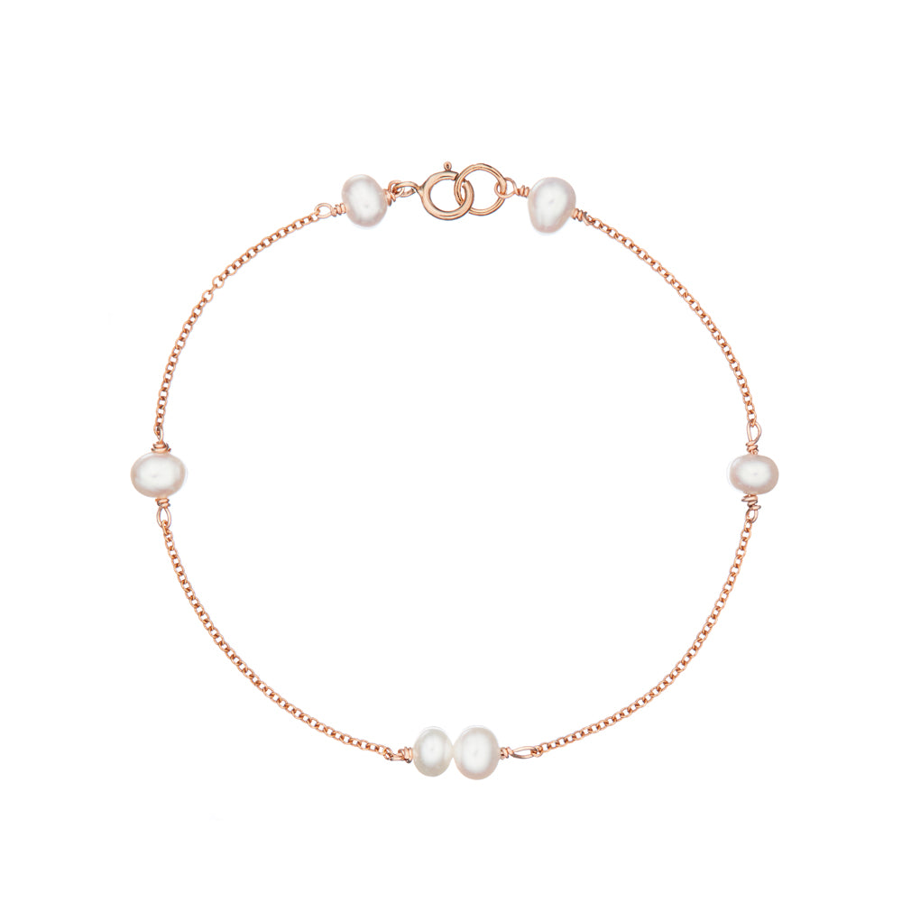 Rose gold six pearl bracelet on a white background