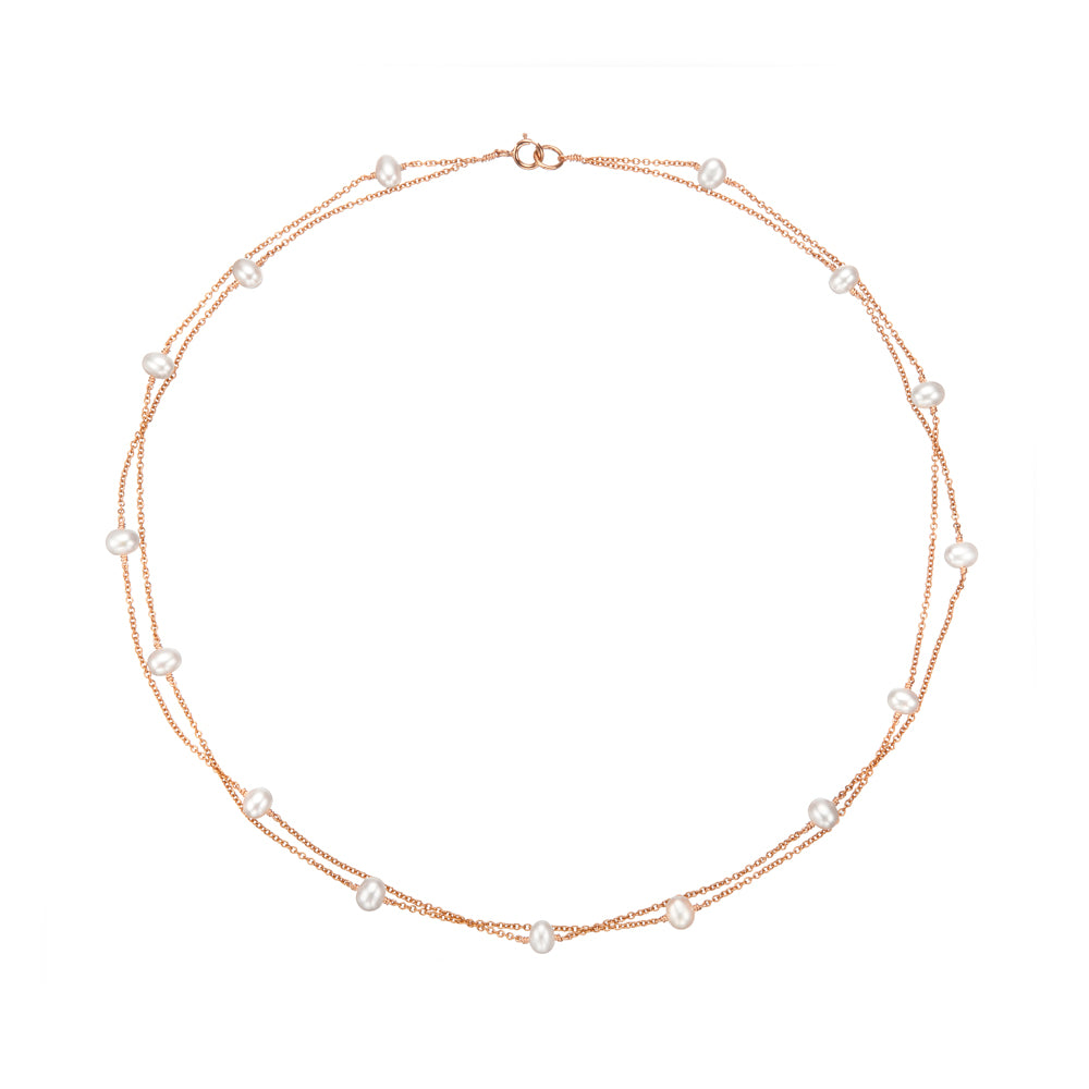 Rose gold layered pearl necklace on a white background