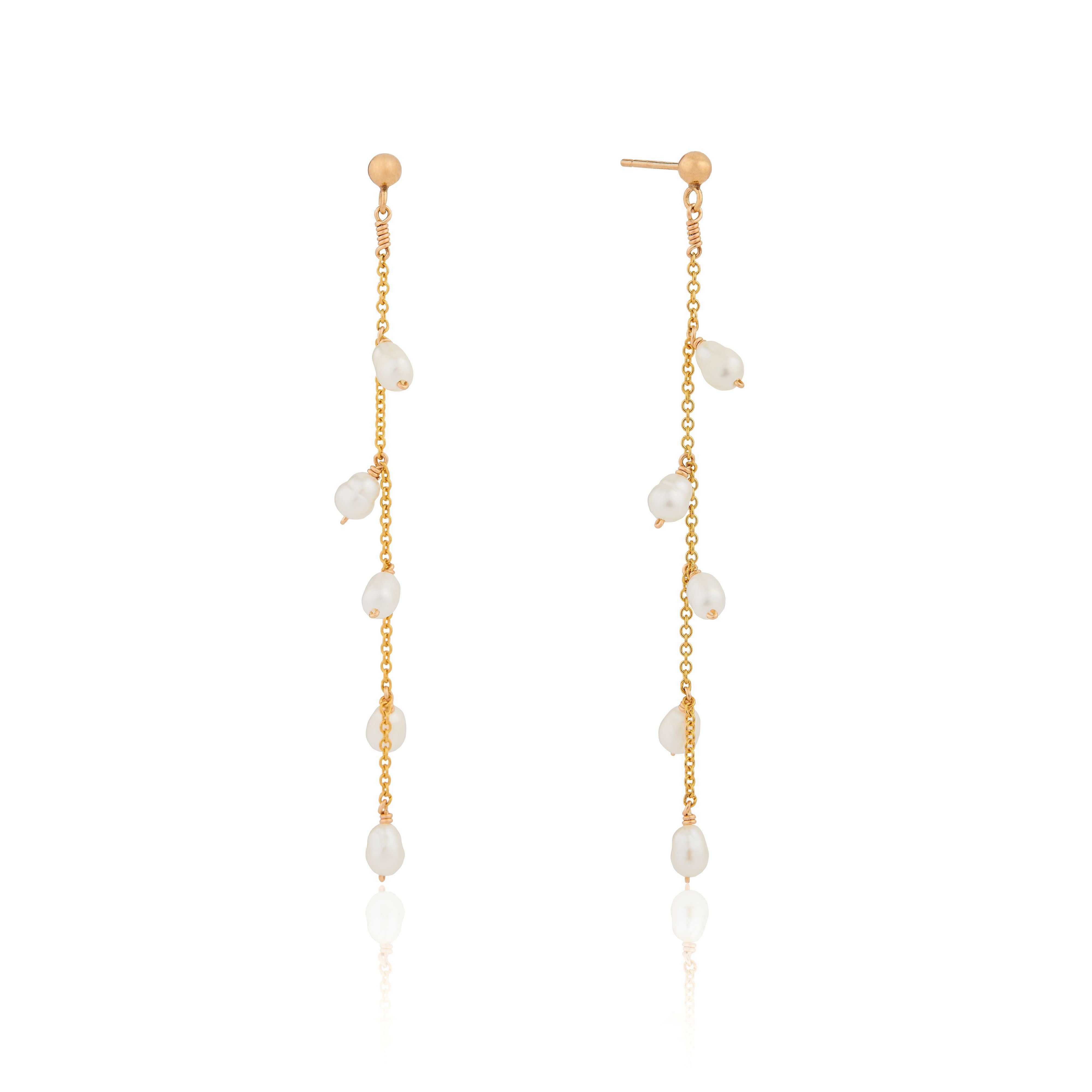 Gold seed pearl drop earrings on a white background