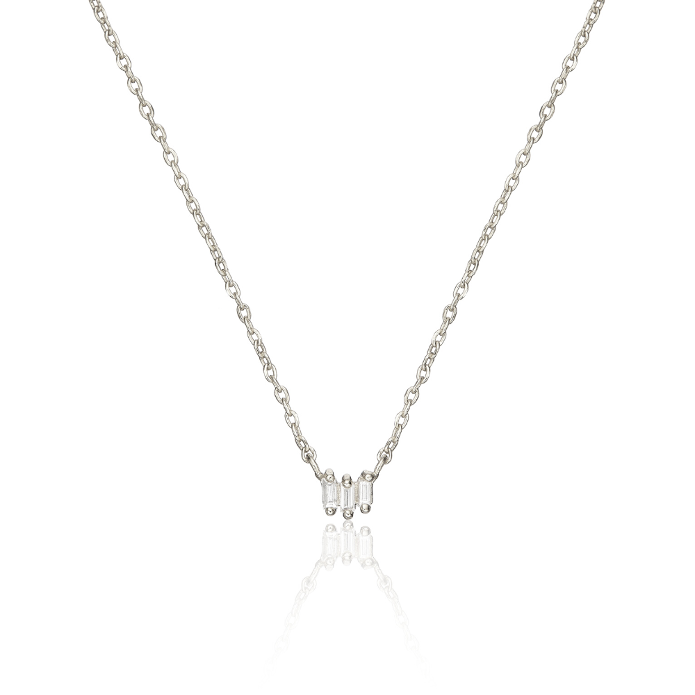 Silver triple baguette diamond necklace on a white background