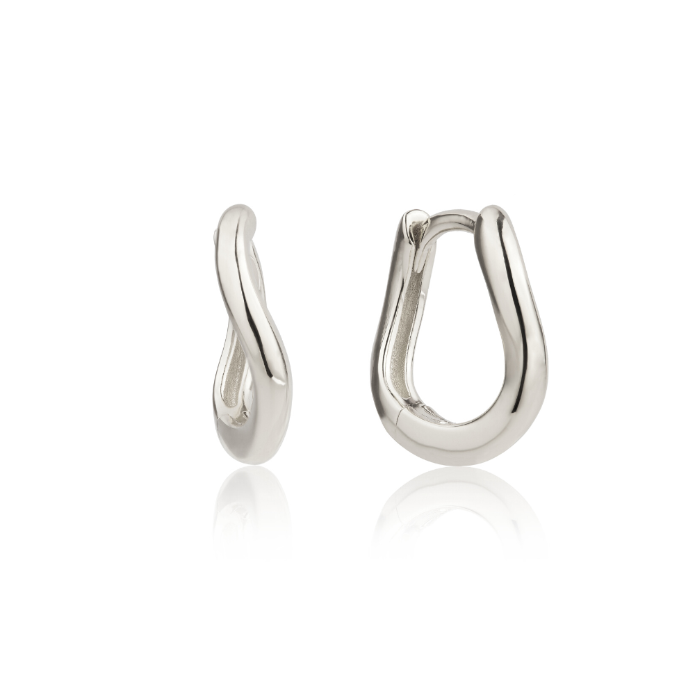 Silver wave huggie hoop earrings on a white background