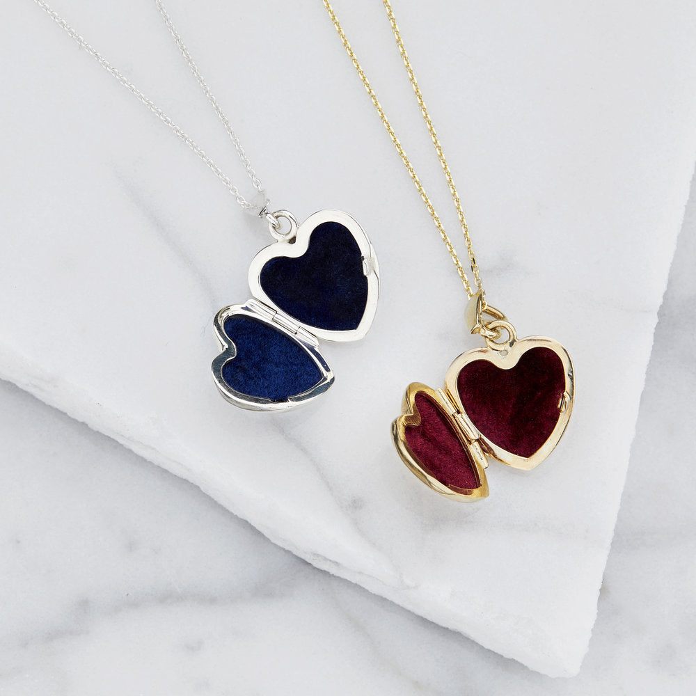 two open silver small heart locket necklaces one with red velvet inside, the other blue velvet