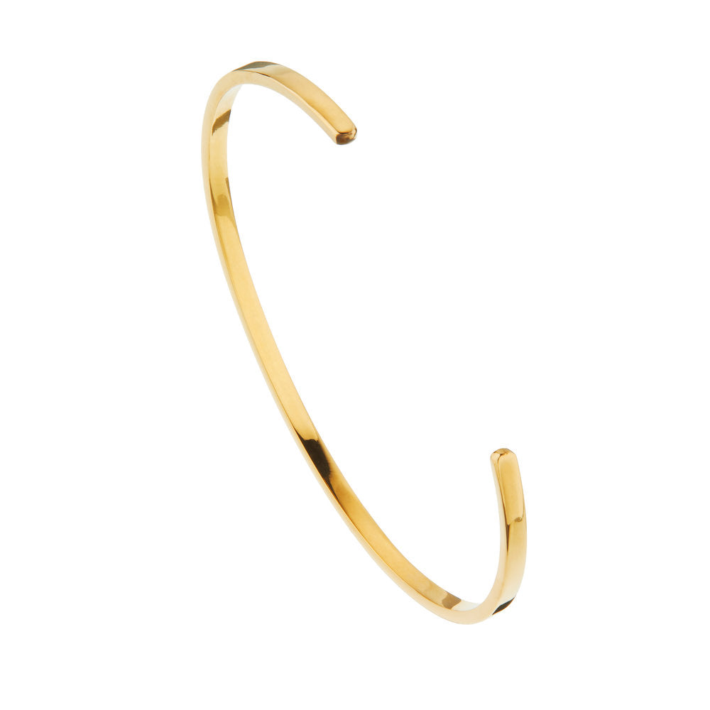 Gold thin engraved bangle on a white background