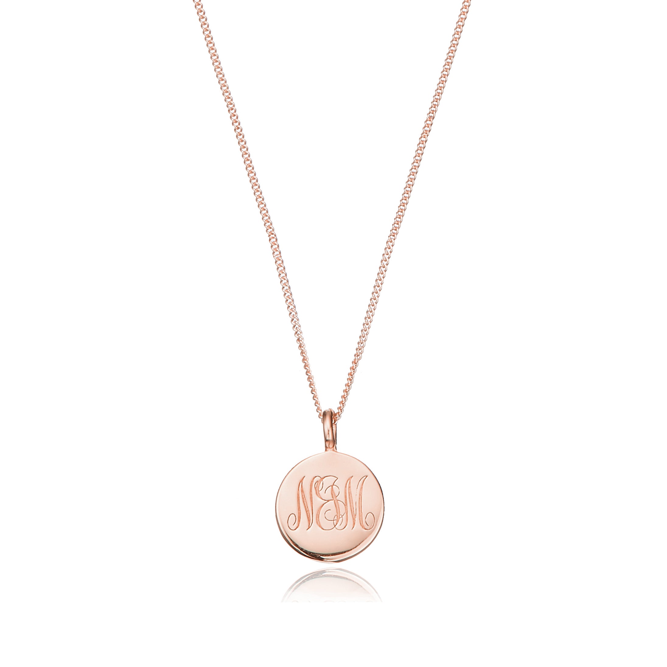 Rose gold large engraved disc necklace with NM engraved on a white background