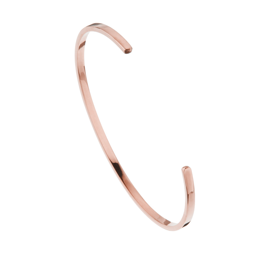 Rose gold thin engraved bangle on a white background