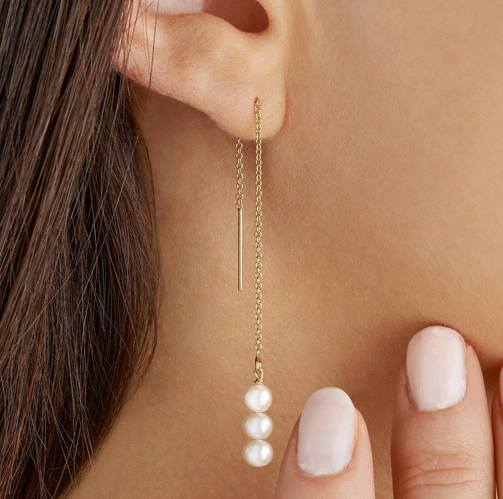 Gold cluster pearl drop ear threader in one ear lobe