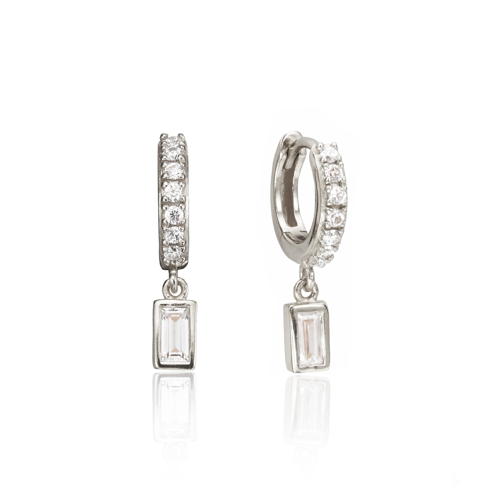 Silver diamond style baguette drop huggie hoop earrings on a white background