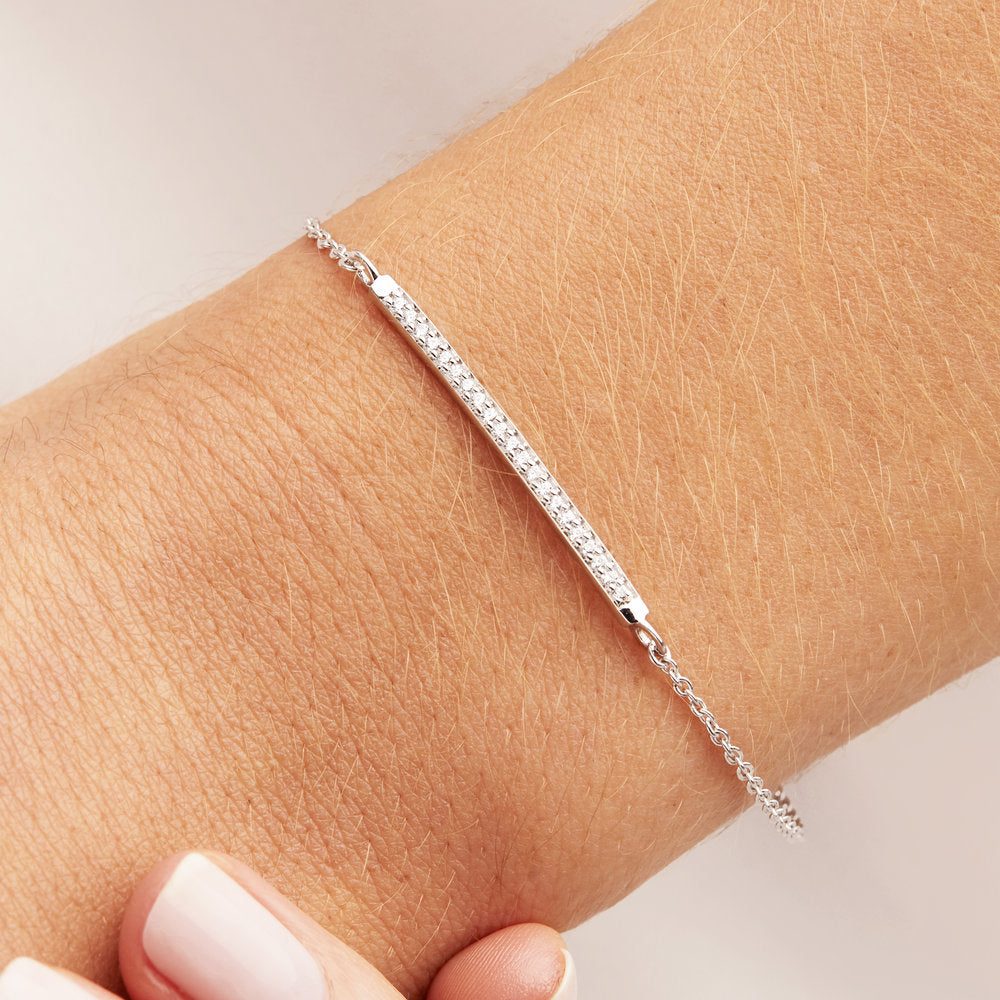 Silver diamond style bar bracelet on a wrist
