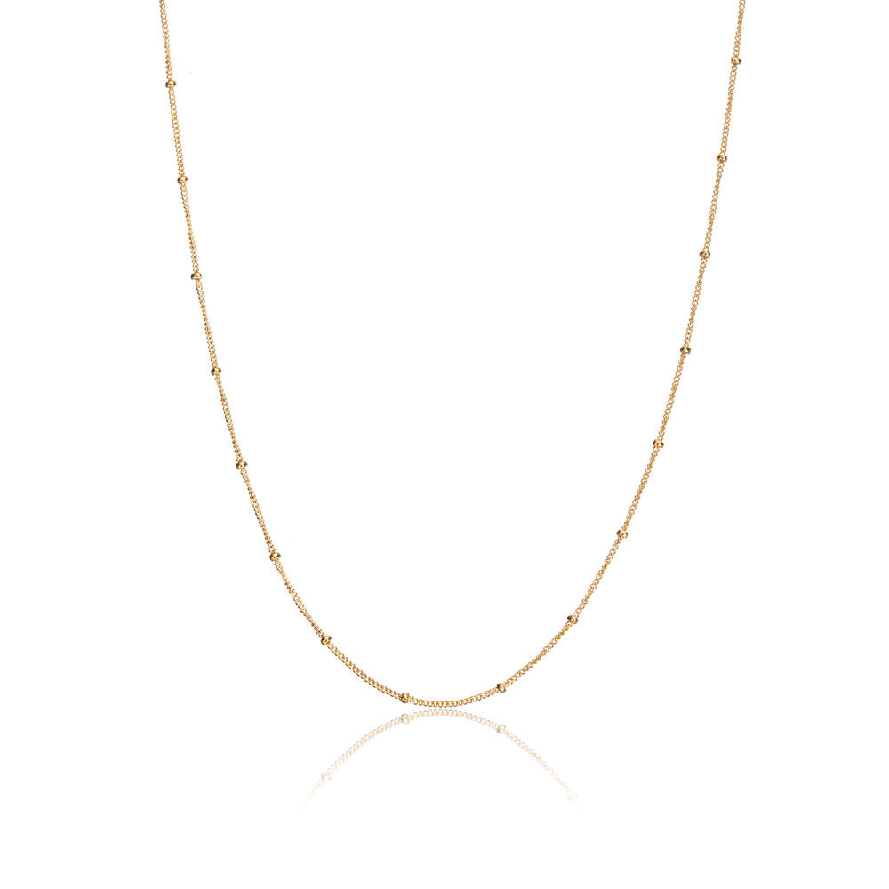 Gold satellite chain necklace on a white background
